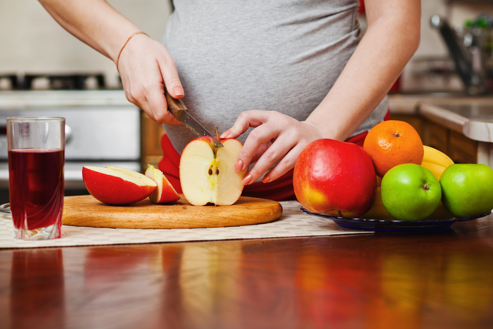 pregnant woman on kitchen with healthy food